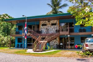 a building with a staircase in front of it at Cabinas El Paso de Moisés in Uvita