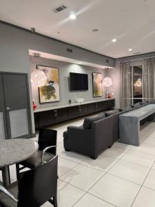 a living room with a couch and a tv at The Experience in Houston
