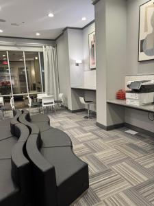 an empty waiting room with chairs and a desk at The Experience in Houston
