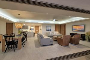 a living room and dining room with a couch and a table at NEW Sonoran Star Luxury condo 2BD, 2BA in Puerto Peñasco
