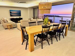 a dining table and chairs in a living room at NEW Sonoran Star Luxury condo 2BD, 2BA in Puerto Peñasco +36 photos