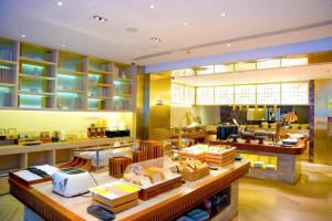 a store with a counter and chairs in a room at Mercure Dalian City Center in Dalian