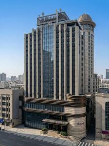 a large building with a crane on top of it at Mercure Dalian City Center in Dalian