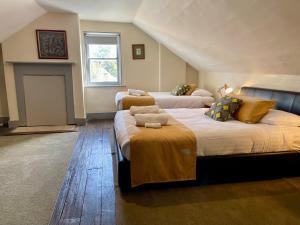 a bedroom with two beds and a window at Whites Corner in Bothwell +12 photos