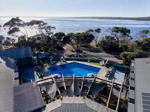an aerial view of a swimming pool and the ocean at Mercure Kangaroo Island Lodge in American River