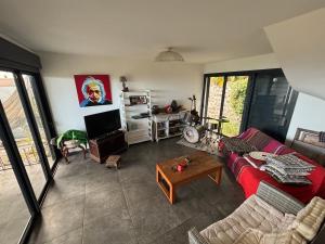 a living room with a red couch and a table at Villa Papang in Saint-Paul