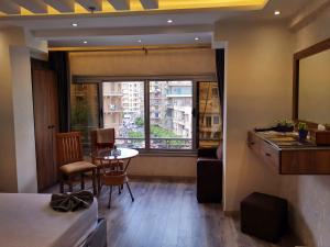 a living room with a table and a window at tourist hotel cairo downtown in Cairo