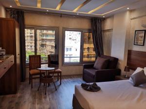 a hotel room with a bed and a table and chairs at tourist hotel cairo downtown in Cairo
