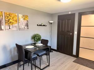 a dining room with a black table and chairs at Leatherhead Studios by WorkStay in Leatherhead