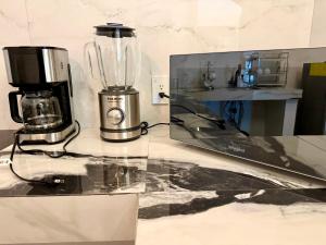 a kitchen counter with a blender and a laptop on it at Mansionality Group in Tlalpujahua de Rayón
