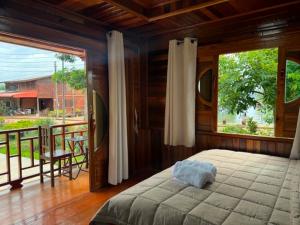 a bedroom with a bed and a large window at Lamphu Resort Koh Lanta at Lanta Old Town in Ko Lanta +31 photos