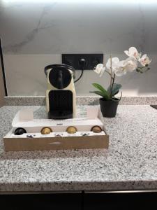 a box of donuts on a counter with a blender at Apartamentos Nuevos en Valencia in Valencia