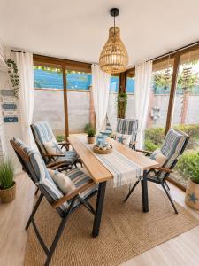 a dining room table with chairs and a chandelier at Happy House in Kranevo