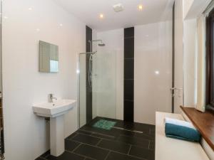 a bathroom with a sink and a shower at Gwylan Uchaf in Y Felinheli +41 photos