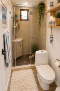 a bathroom with a shower with a toilet and a sink at Happy House in Kranevo +6 photos
