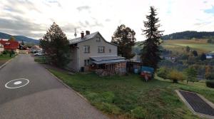 a white house on the side of a road at Apartmany Pohoraly in Rokytnice nad Jizerou