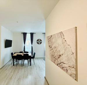 a dining room with a table and a wall at Apartmány 68 in Kámen