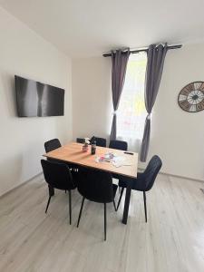 a dining room table and chairs in a room at Apartmány 68 in Kámen