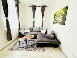 a living room with a couch and a table at Apartmány 68 in Kámen