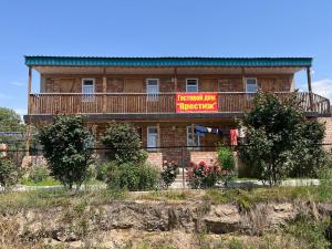 a large brick building with a sign on it at Prestizh Guest House in Tamchy