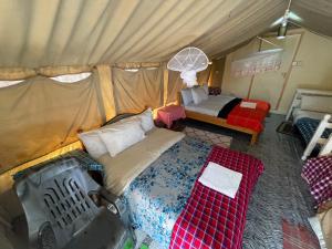 an aerial view of a bedroom with a tent at Ntito Mara lodge in Maasai Mara National Reserve