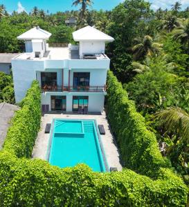 an aerial view of a house with a swimming pool at LoSu Polhena in Polhena