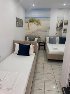 a room with two beds and a couch at Spile Rooms Lukas in Himare