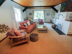 a living room with a couch and a table at The Stables in Flemingston