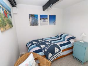 a bedroom with a twin bed and a blue cabinet at The Stables in Flemingston