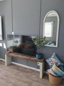 a table with a potted plant on it in a room at 7onthebeach unit 3 in Jeffreys Bay