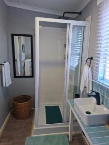 a bathroom with a shower and a sink at 7onthebeach unit 3 in Jeffreys Bay +10 photos
