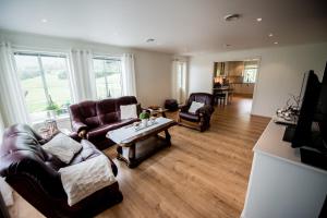 a living room with two couches and a table at Viken Holiday Home in Viksdalen