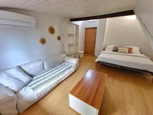a living room with a couch and a bed at Apartment Učka Home in Tuliševica