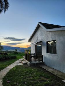 a small white house with a sunset in the background at Mon Desir Estate - NR3 in Pietermaritzburg