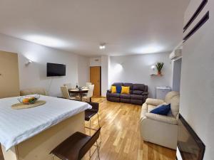 a living room with a table and a couch at Apartment Učka Home in Tuliševica