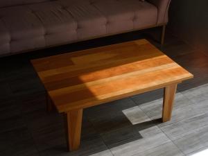 a wooden coffee table in front of a couch at Margarita in Oaxaca City