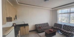 a kitchen with a couch and a table in a room at sadam nahwi in Dukem