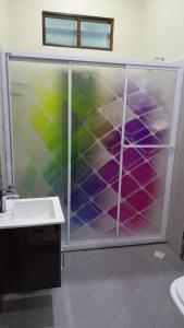 a bathroom with a glass shower with a sink at DBukit Losong Villa Kuala Terengganu in Kuala Terengganu