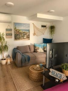a living room with a couch and a television at Casa M in Kranevo