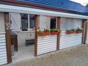 a building with potted plants on the side of it at Studio Clos-Edeen in Tréclun +12 photos