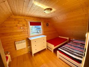 a small room with a bed and a window at Przystanek Wyspa in Gdańsk