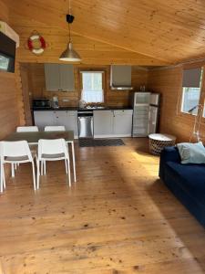 a kitchen and living room with a table and chairs at Przystanek Wyspa in Gdańsk