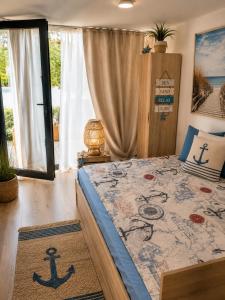 a bedroom with a bed with an anchor rug at Casa M in Kranevo