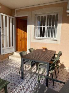 a wooden table and chairs on a patio at Voulez Vous in Lo Pagán