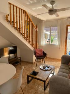 a living room with a staircase and a table at Voulez Vous in Lo Pagán