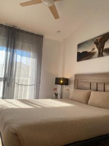 a bedroom with a bed and a ceiling fan at Voulez Vous in Lo Pagán