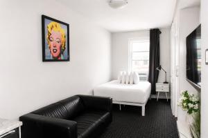 a living room with a couch and a bed at Comfortable Studio in Back Bay, Newbury St. #7 in Boston