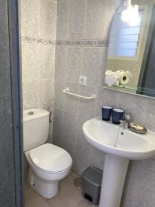 a bathroom with a toilet and a sink and a mirror at Voulez Vous in Lo Pagán +24 photos