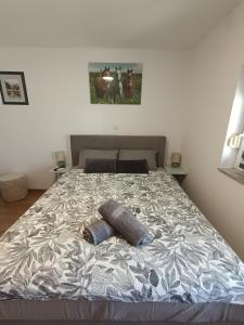 a bed with two pillows on it in a bedroom at Sleepover Room K&M in Novoselec