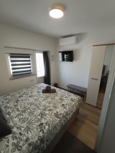 a bedroom with a bed with a flowery comforter at Sleepover Room K&M in Novoselec +3 photos